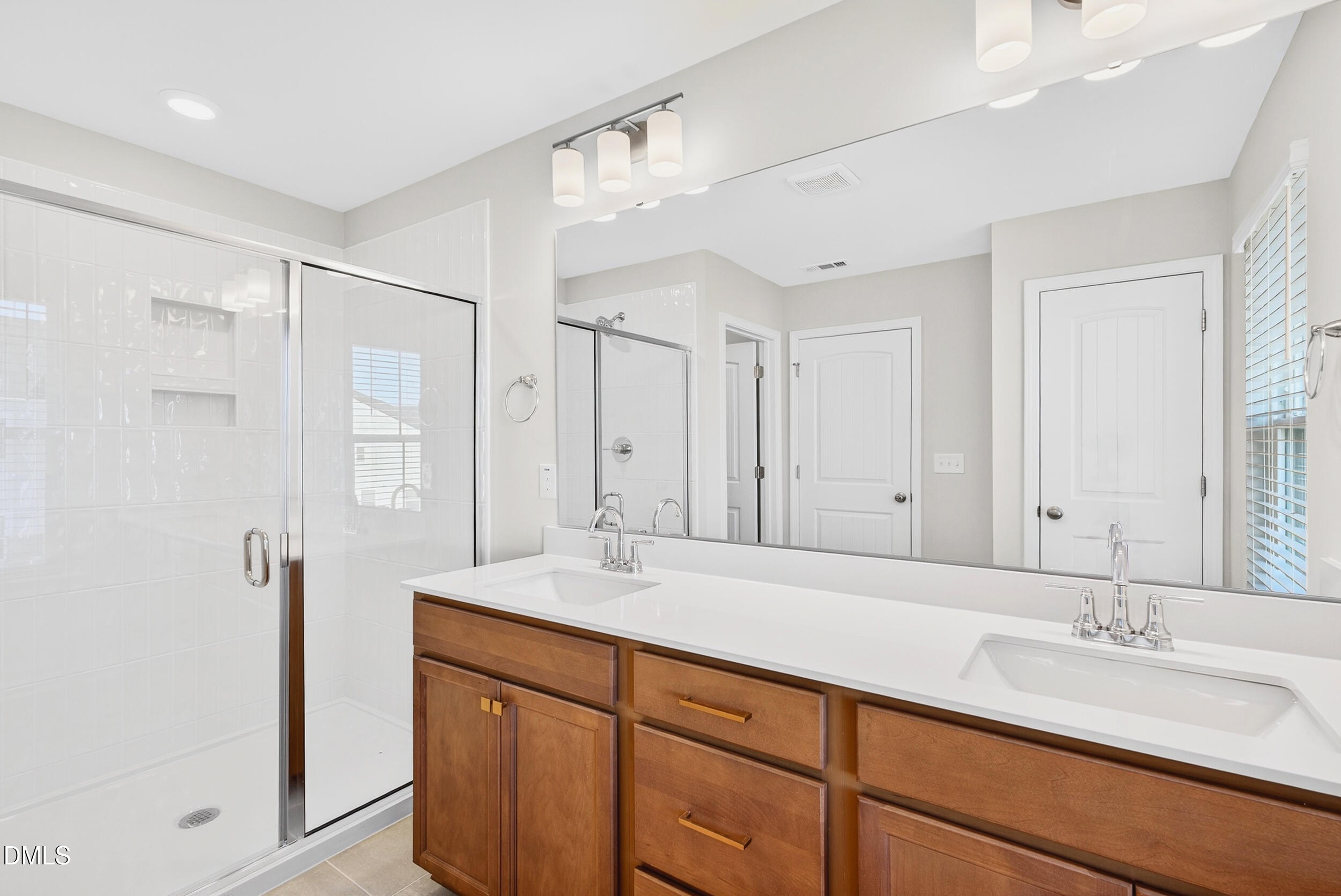 335 Chesapeake Commons Street Garner, NC 27529 - Photo 11 of 20 a bathroom with a sink double vanity and a mirror