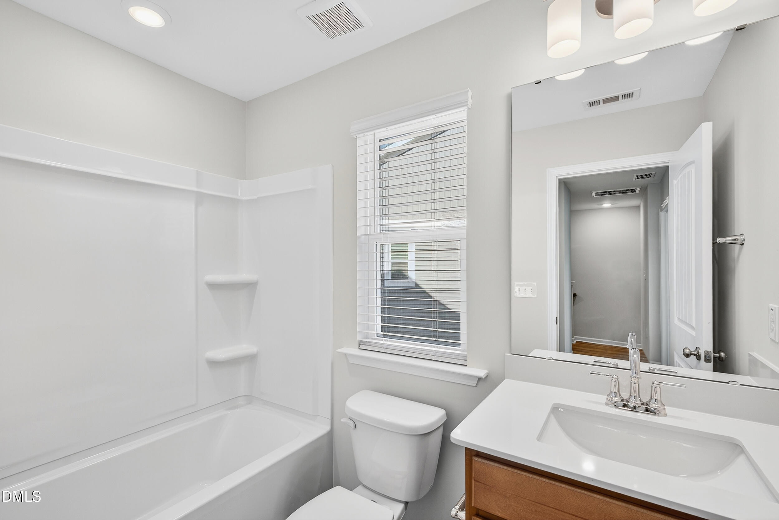 335 Chesapeake Commons Street Garner, NC 27529 - Photo 16 of 20 a bathroom with a sink toilet vanity and bathtub
