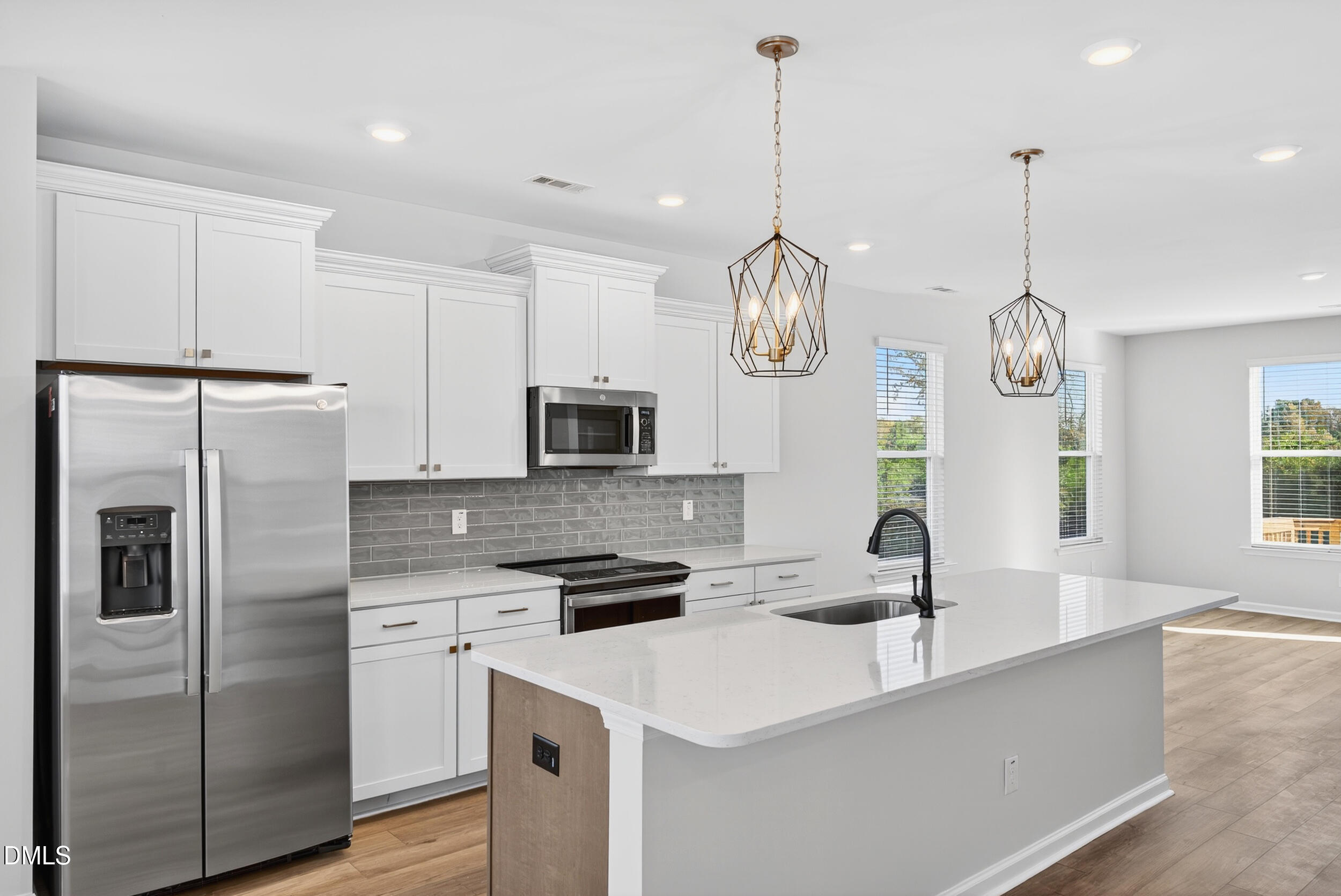 335 Chesapeake Commons Street Garner, NC 27529 - Photo 6 of 20 a kitchen with stainless steel appliances granite countertop a sink a stove and a refrigerator