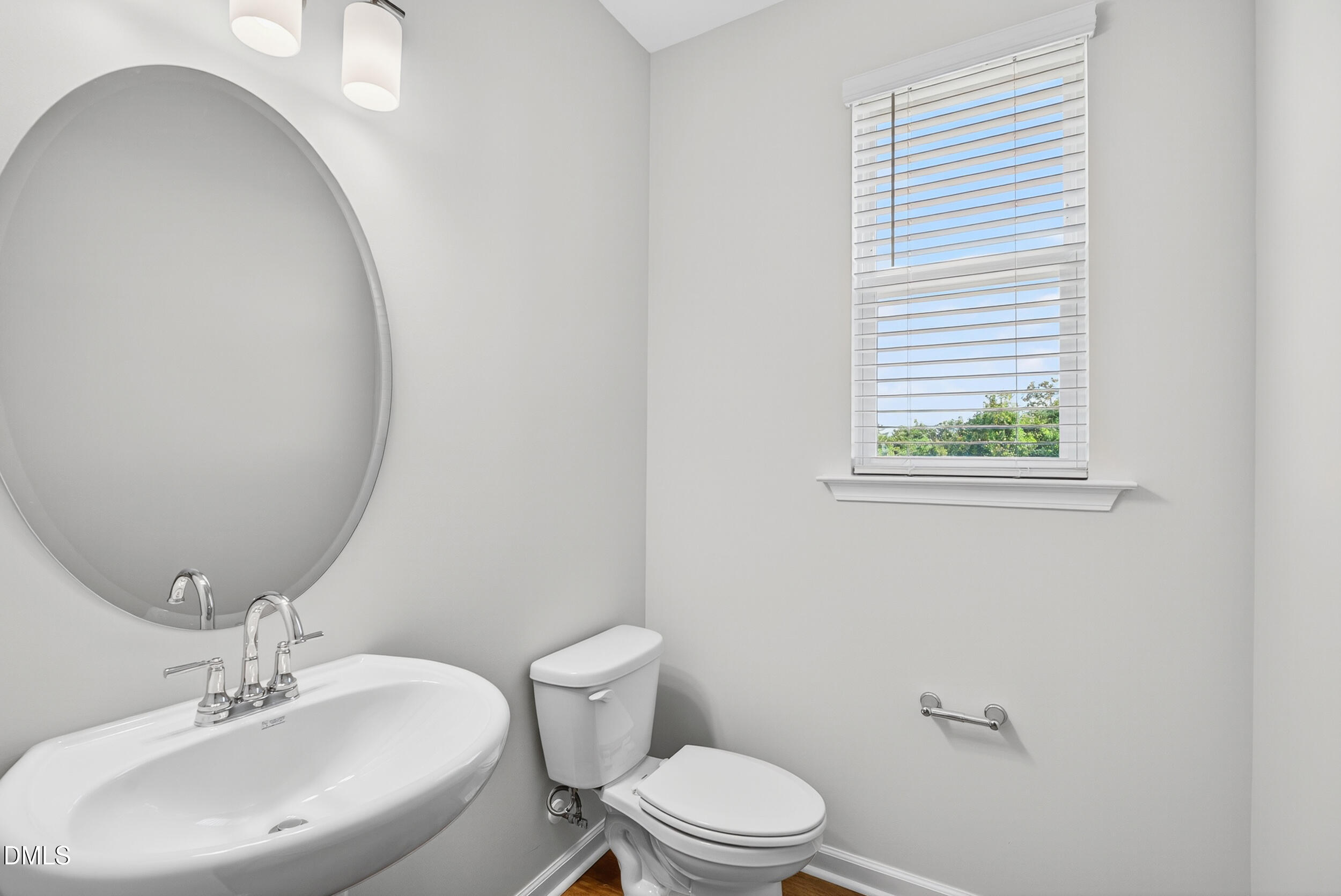 335 Chesapeake Commons Street Garner, NC 27529 - Photo 9 of 20 a bathroom with a sink a toilet and mirror