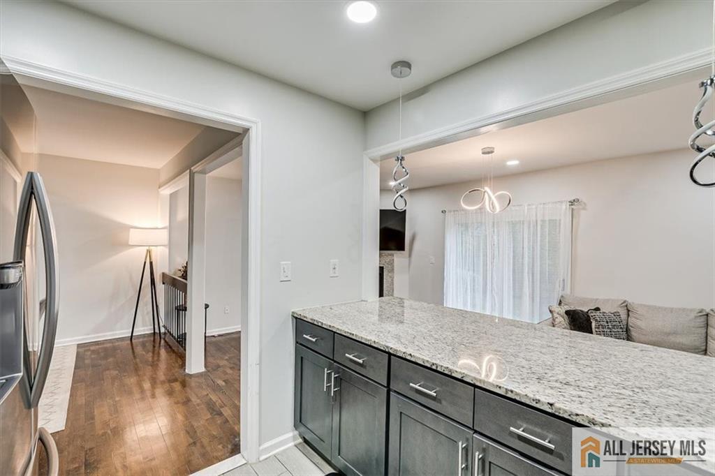 3003 Hana Road Edison, NJ 08817 - Photo 19 of 45 a bathroom with a granite countertop sink and a mirror