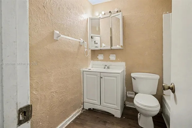 a white toilet sitting next to a bathroom sink