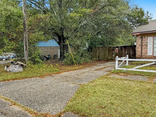 a view of a chair and table in backyard of the house
