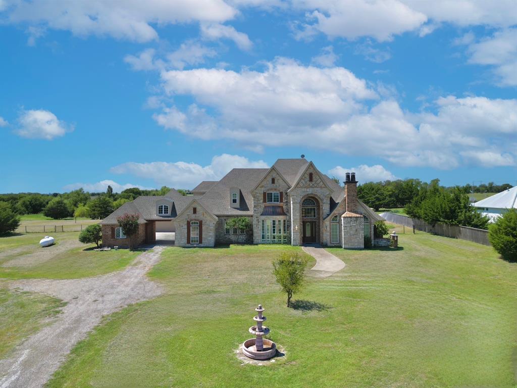a large house with a big yard and large trees