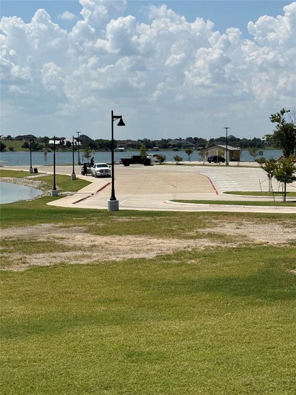 4026 Howard Road Waxahachie, TX 75165 - Photo 12 of 37 a view of a large swimming pool and a lake
