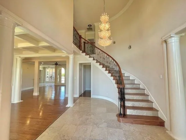 a view of entryway and hall with wooden floor