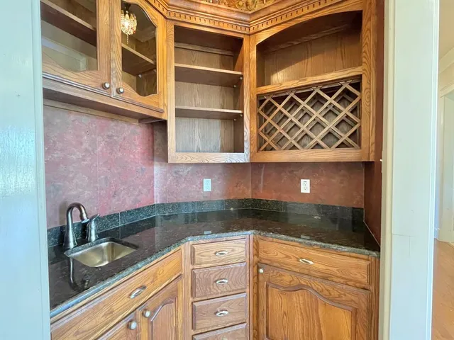a kitchen with granite countertop stainless steel appliances and cabinets