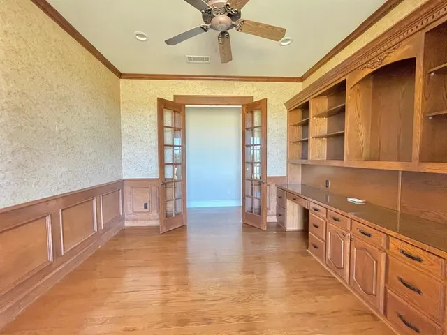 a large kitchen with stainless steel appliances a large counter top space and cabinets