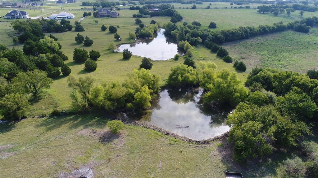 4026 Howard Road Waxahachie, TX 75165 - Photo 9 of 37 an aerial view of a house with a yard and lake
