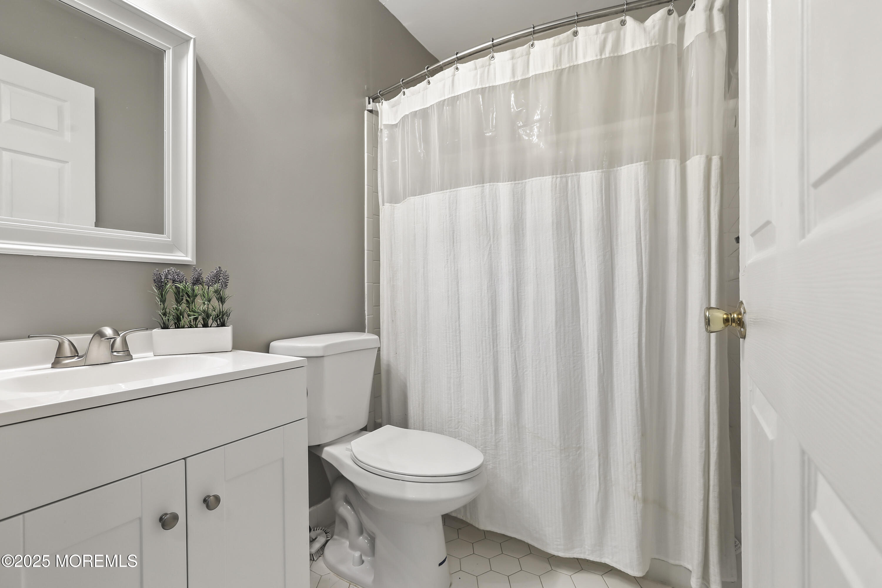 1707 Ridgeview Court, Unit 1707 Parlin, NJ 08859 - Photo 18 of 22 a bathroom with a white sink a toilet and a mirror