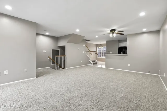 an empty room with a kitchen and a sink