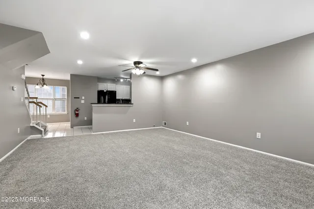 a view of a kitchen with a sink and a refrigerator