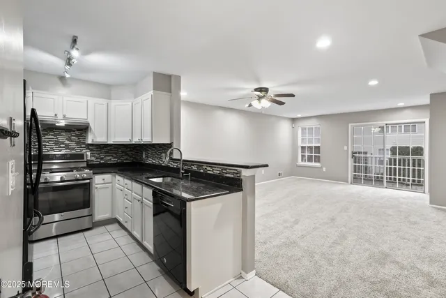 a kitchen with stainless steel appliances granite countertop a stove and a sink