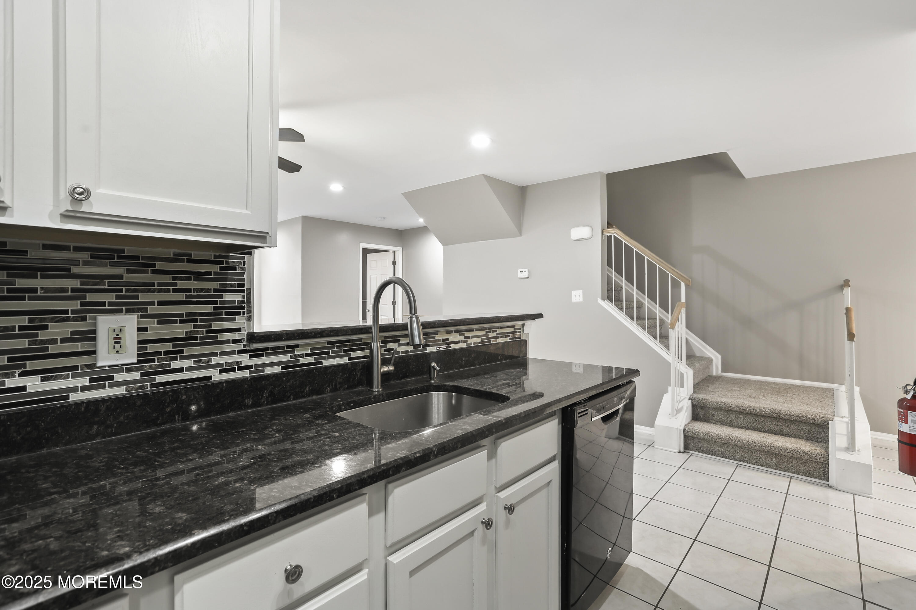 1707 Ridgeview Court, Unit 1707 Parlin, NJ 08859 - Photo 7 of 22 a kitchen with granite countertop a sink and cabinets