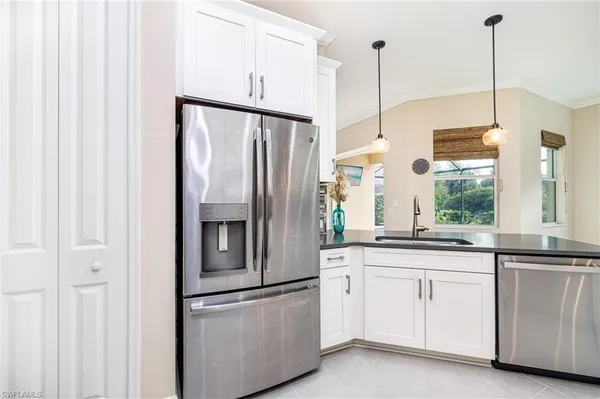 a kitchen with white cabinets and white appliances