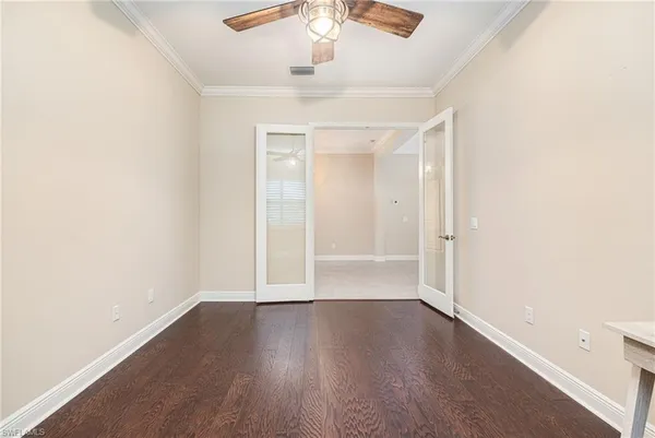 an empty room with wooden floor and window