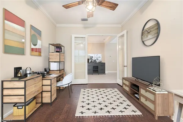a living room with furniture a flat screen tv and a window