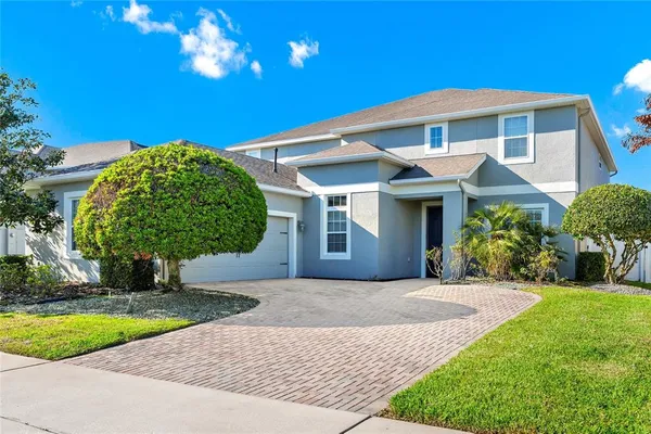 a front view of a house with a yard and garage