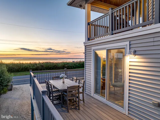 a view of a balcony and yard with wooden fence