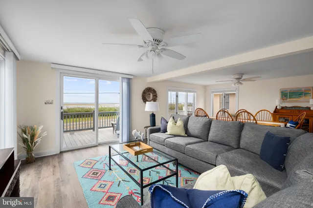 a living room with furniture a rug and a chandelier
