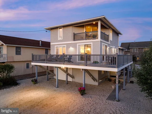 an aerial view of a house with garden space and lake view