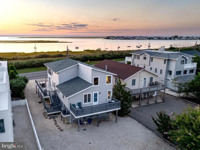 a view of a balcony with two chairs and wooden fence