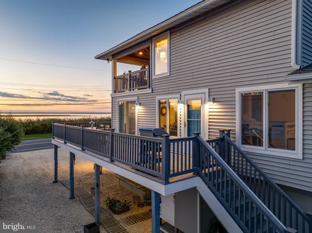 a kitchen with a dining table chairs sink and white cabinets