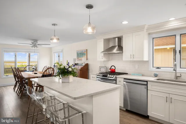 a kitchen with stainless steel appliances granite countertop a stove a sink a refrigerator and a refrigerator