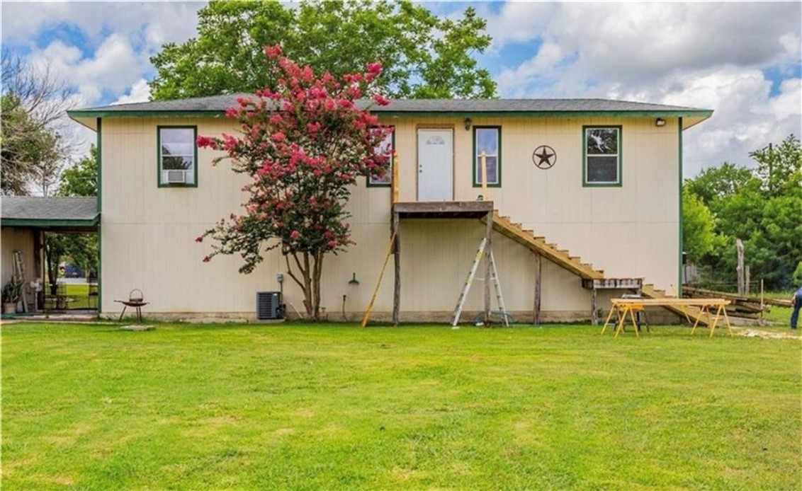 a white house that has a tree in front of it