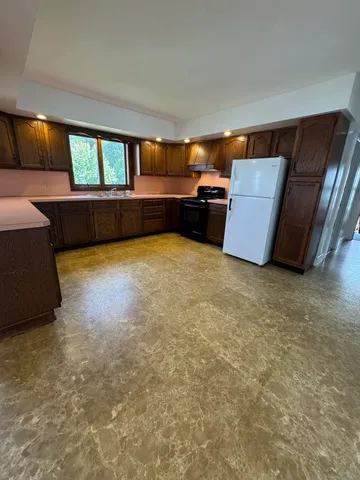 a view of room with window and a kitchen