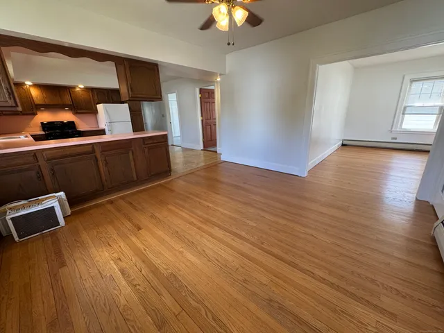 a view of a room with wooden floor and staircase