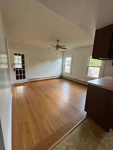 wooden floor in an empty room with a window