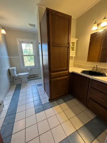 a kitchen with a refrigerator and a sink