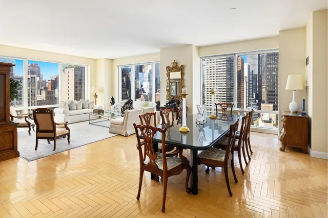a living room with furniture and floor to ceiling windows