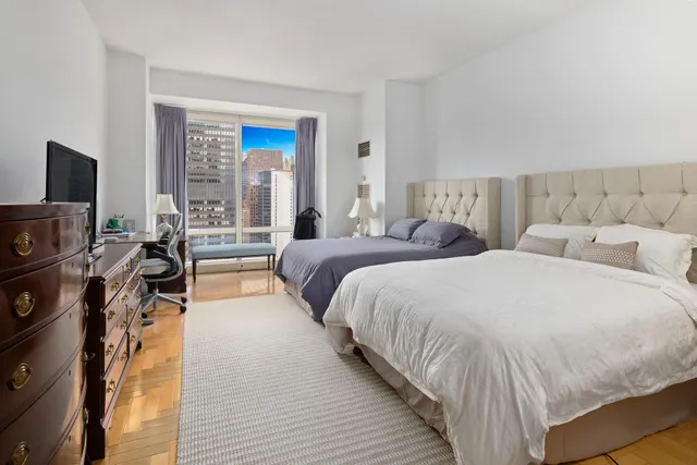 a kitchen with stainless steel appliances granite countertop a stove a sink dishwasher a dining table and chairs with wooden floor