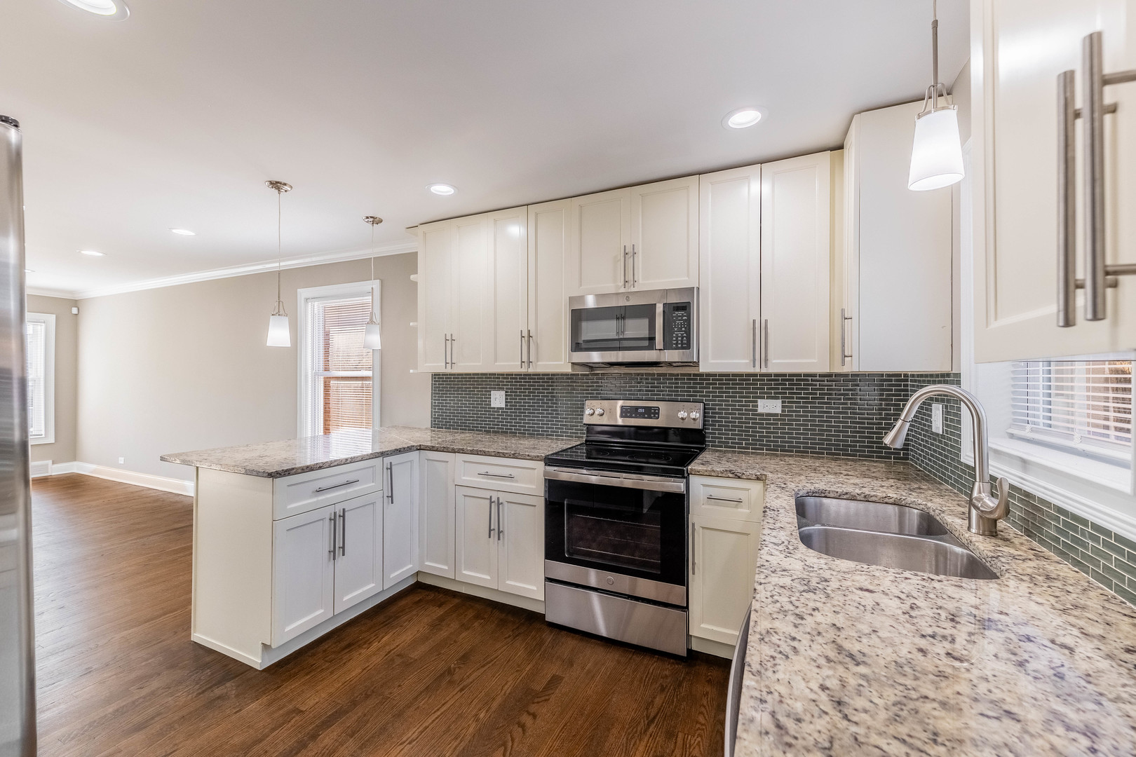 7914 South Troy Street Chicago, IL 60652 - Photo 11 of 35 a kitchen with stainless steel appliances granite countertop a sink stove microwave and refrigerator