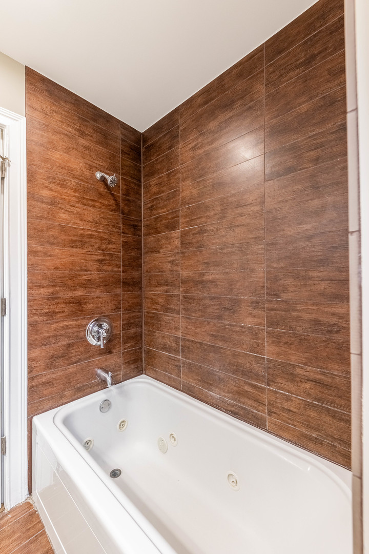 7914 South Troy Street Chicago, IL 60652 - Photo 13 of 35 a bathroom with a bathtub and shower
