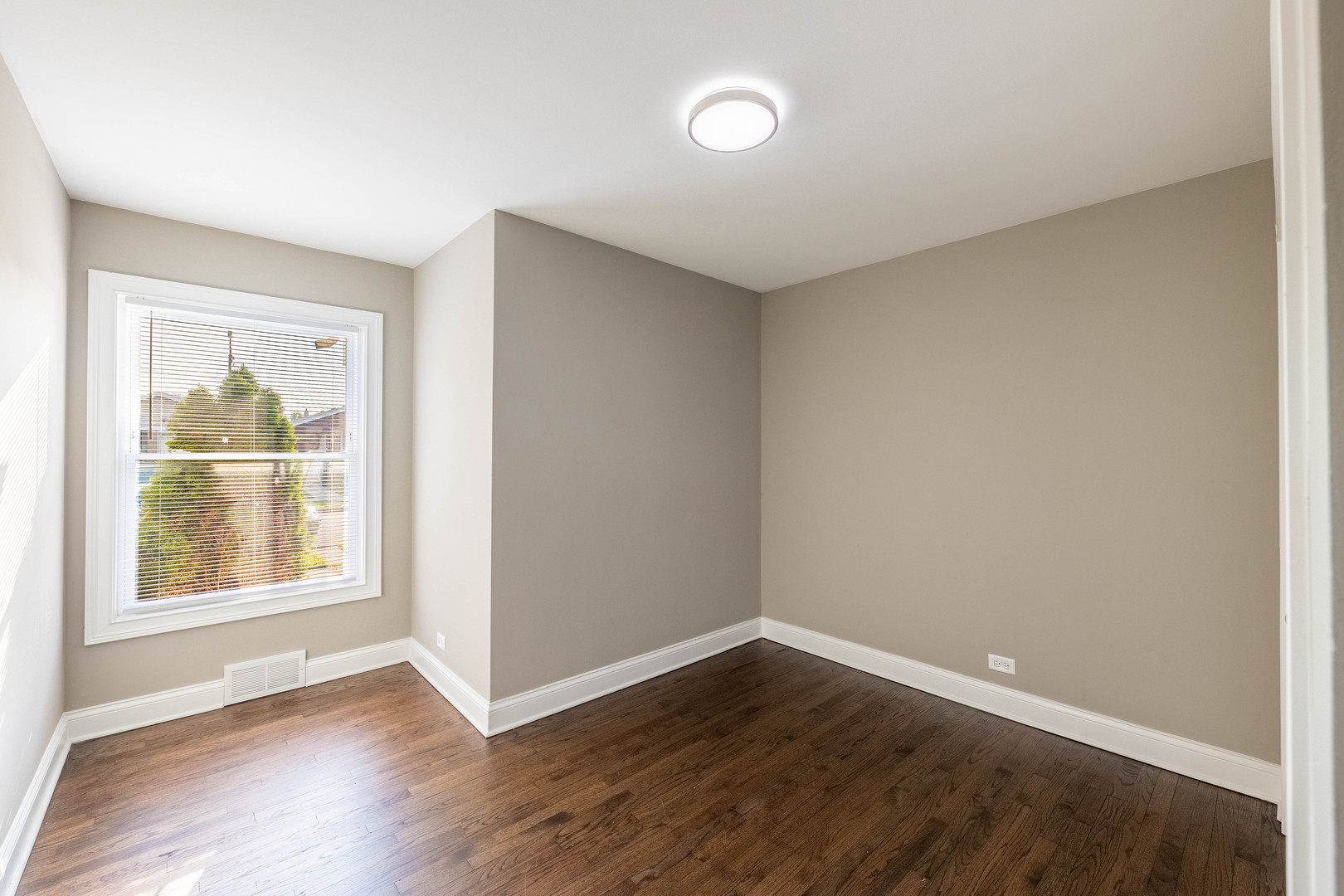 7914 South Troy Street Chicago, IL 60652 - Photo 14 of 35 an empty room with wooden floor and windows