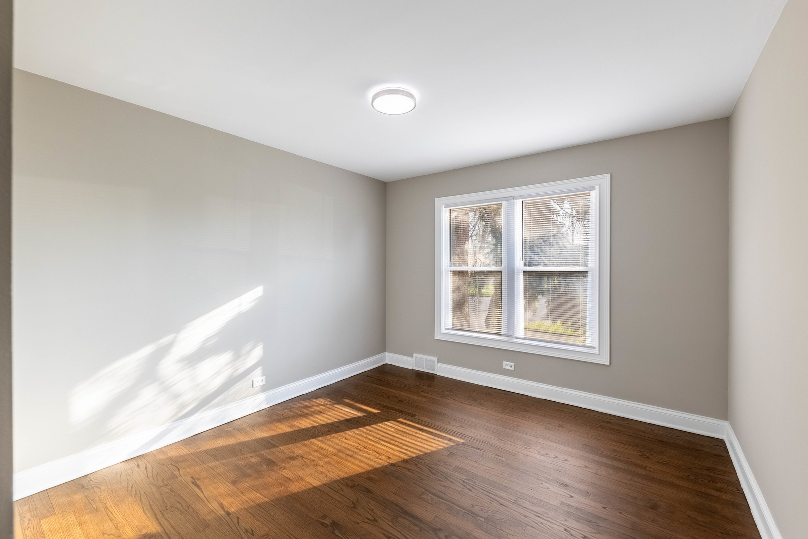 7914 South Troy Street Chicago, IL 60652 - Photo 18 of 35 an empty room with wooden floor and windows