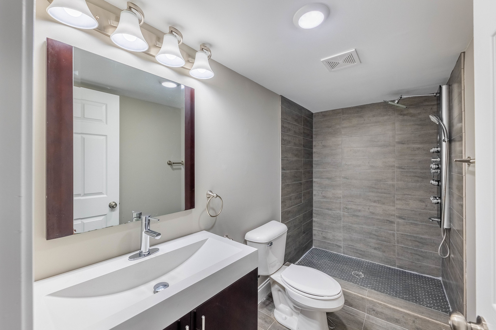 7914 South Troy Street Chicago, IL 60652 - Photo 30 of 35 a bathroom with a sink a toilet a mirror and shower