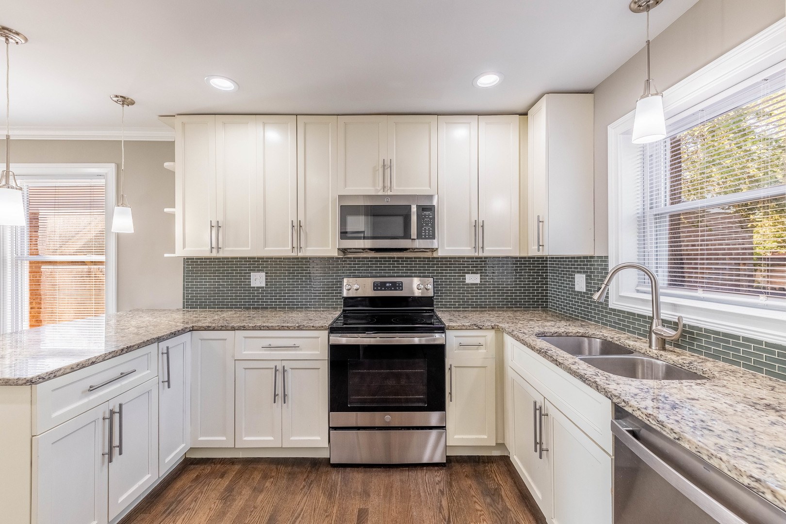 7914 South Troy Street Chicago, IL 60652 - Photo 10 of 35 a kitchen with granite countertop white cabinets white stainless steel appliances a sink and a window