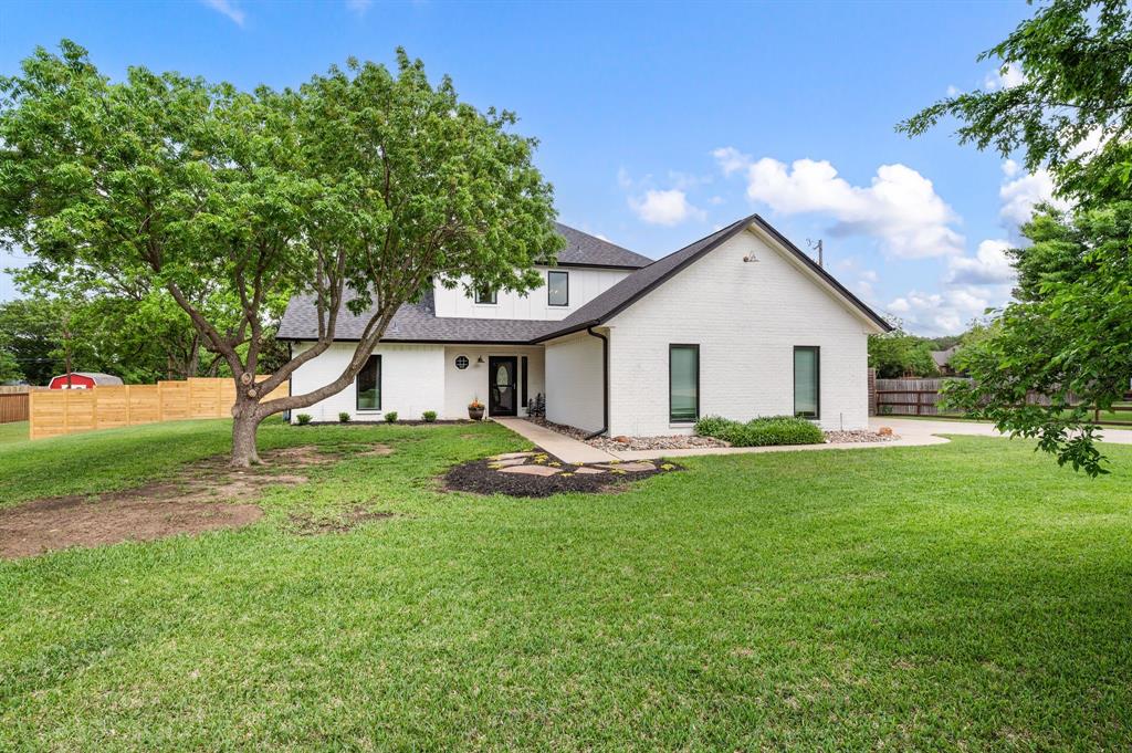 a view of a house with a yard and a garden