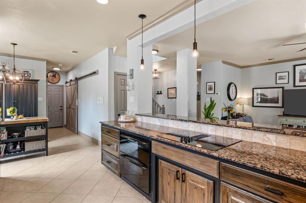 508 Chandler Road Keller, TX 76248 - Photo 9 of 39 a kitchen with stainless steel appliances granite countertop a sink a stove and a wooden cabinets