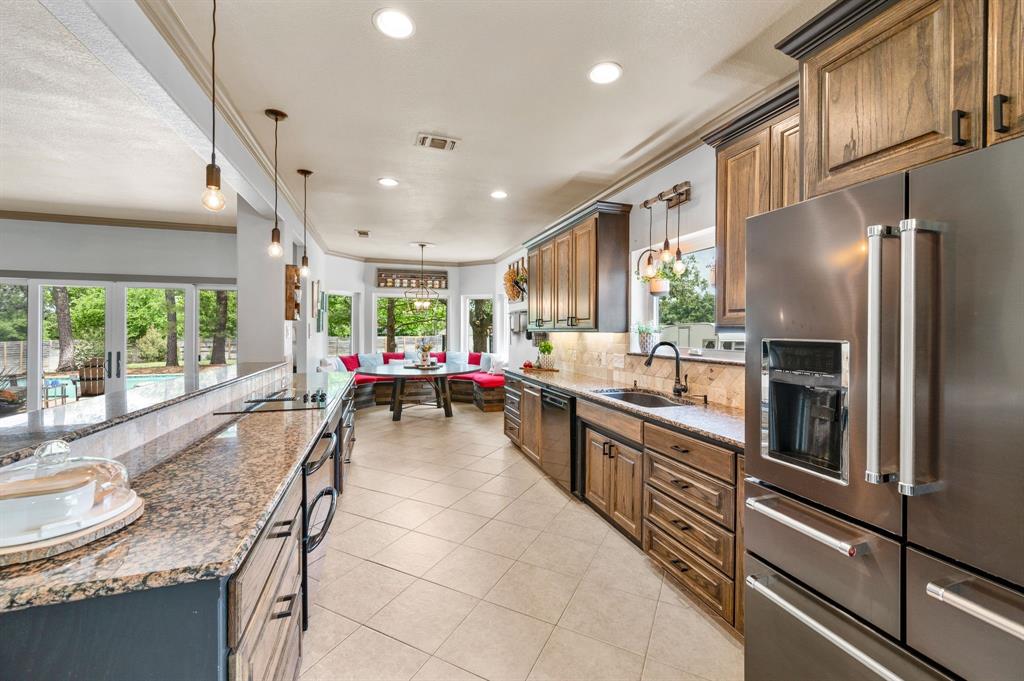 508 Chandler Road Keller, TX 76248 - Photo 11 of 39 a large kitchen with kitchen island granite countertop a large window cabinets and stainless steel appliances