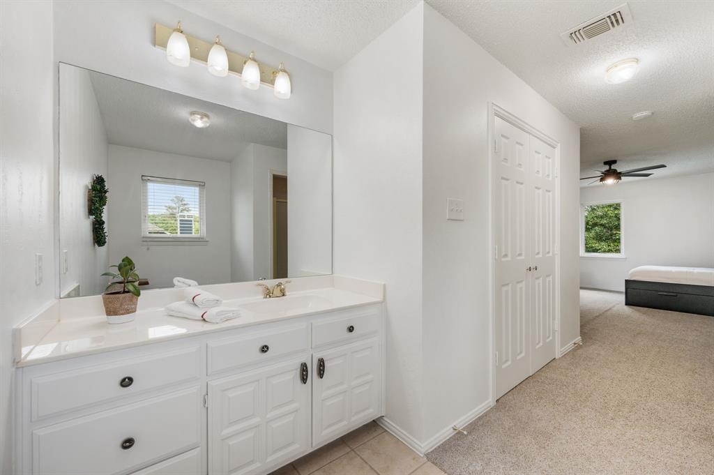508 Chandler Road Keller, TX 76248 - Photo 22 of 39 a bathroom with a granite countertop sink mirror and toilet
