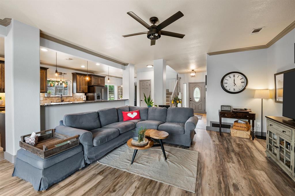 508 Chandler Road Keller, TX 76248 - Photo 38 of 39 a living room with furniture kitchen view and a wooden floor