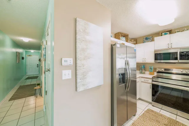 a kitchen with stainless steel appliances a refrigerator and a stove top oven