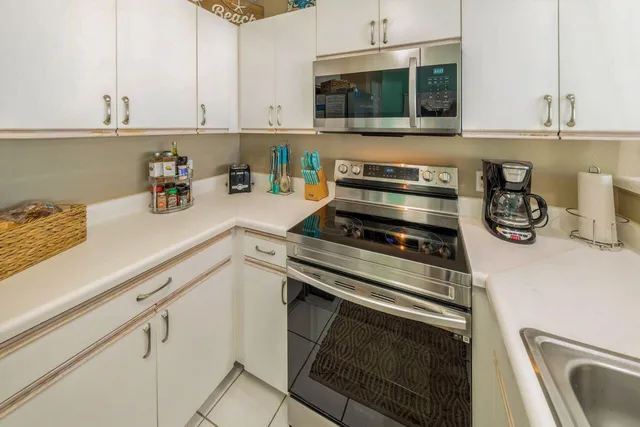 a kitchen with a stove and a white cabinets