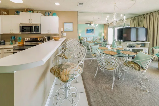 a kitchen with stainless steel appliances kitchen island granite countertop a sink and cabinets