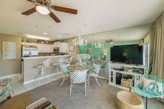 a dining room with furniture and a flat screen tv